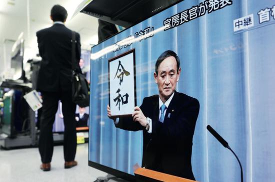 2019年4月1日，日本东京一家电器商城的电视机正在转播报道：日本内阁官房长官菅义伟在首相官邸公布新年号为“令和”。图/新华